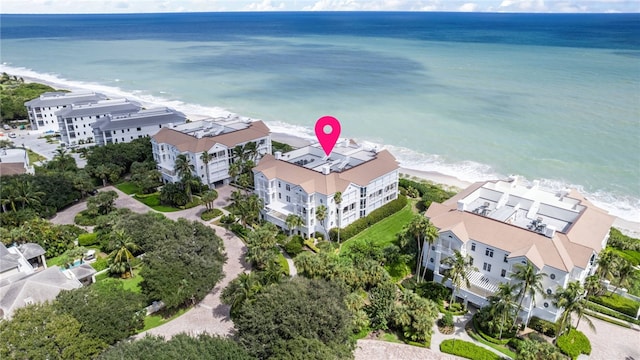 birds eye view of property with a water view and a view of the beach