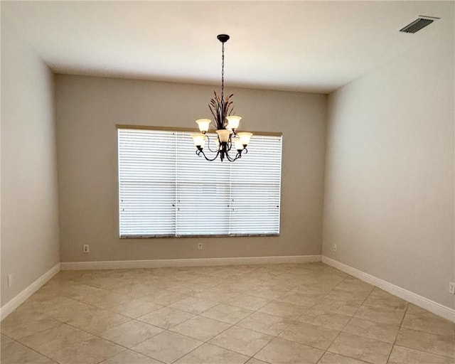 unfurnished room featuring a notable chandelier