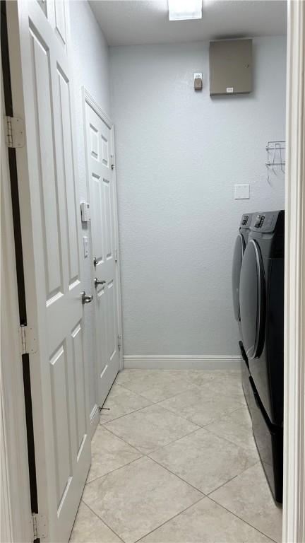 laundry area featuring light tile patterned flooring and separate washer and dryer