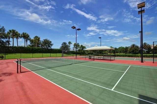 view of tennis court featuring basketball hoop