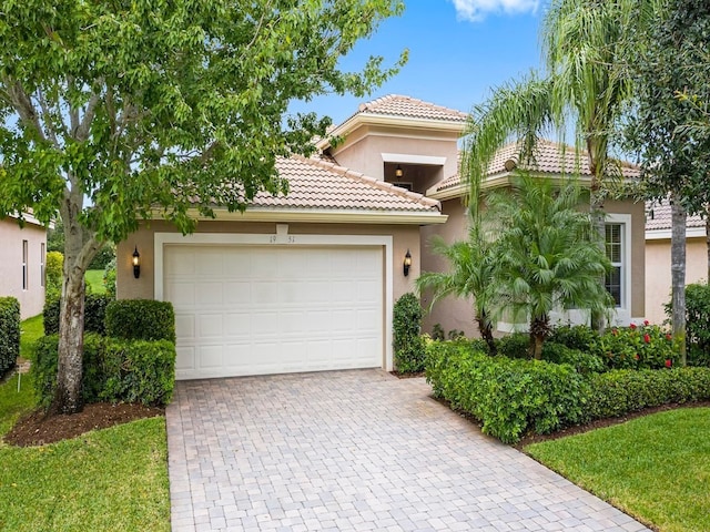 mediterranean / spanish home with a garage