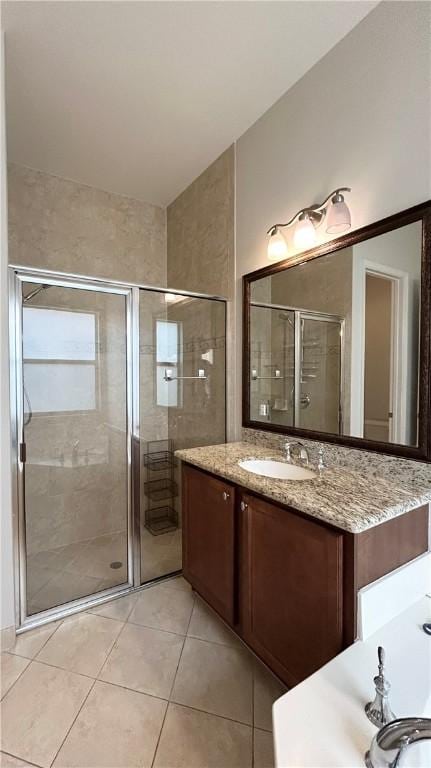 bathroom with tile patterned flooring, vanity, and an enclosed shower