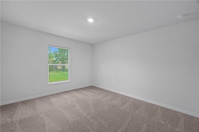 7724 104th Ave, Vero Beach, FL 32967 - carpeted empty room featuring baseboards, a smoke detector, and recessed lighting