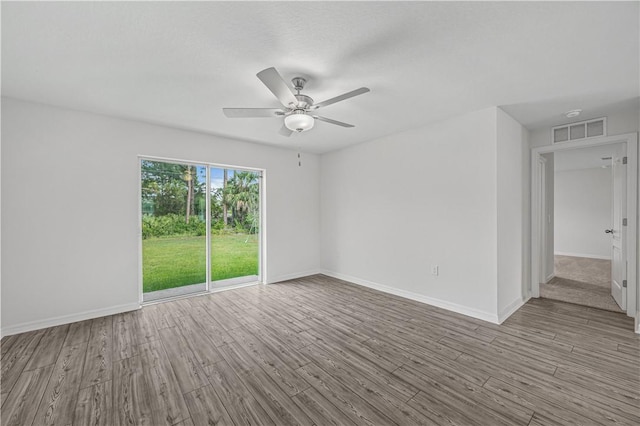 7724 104th Ave, Vero Beach, FL 32967 - empty room featuring a ceiling fan, wood finished floors, and baseboards