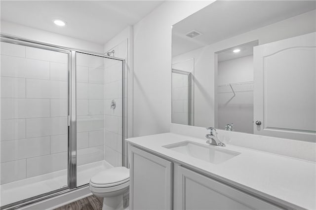 7724 104th Ave, Vero Beach, FL 32967 - full bathroom featuring vanity, a stall shower, toilet, and recessed lighting