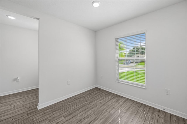 7724 104th Ave, Vero Beach, FL 32967 - empty room with wood finished floors, baseboards, and recessed lighting