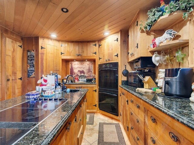 kitchen with wooden ceiling, sink, dark stone counters, and black appliances