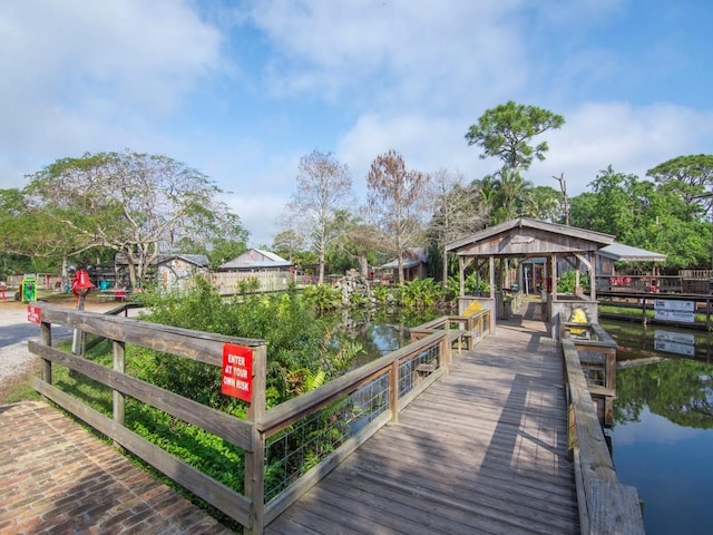 view of dock featuring a gazebo and a water view