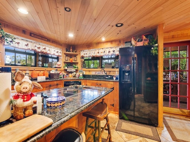 kitchen featuring black fridge, sink, light tile patterned floors, and wooden ceiling