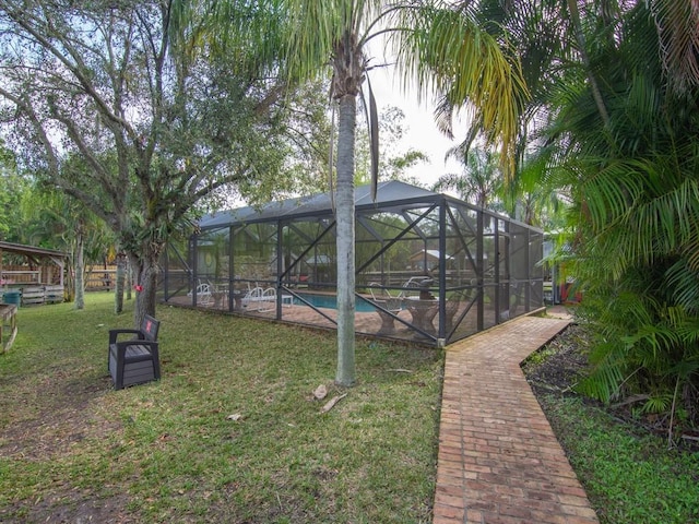 view of yard with glass enclosure