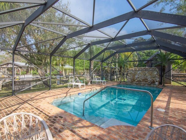 view of pool featuring a lanai and a patio area