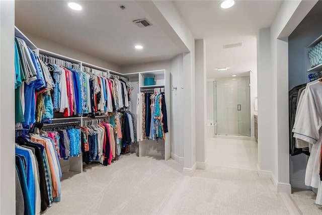 spacious closet featuring light carpet