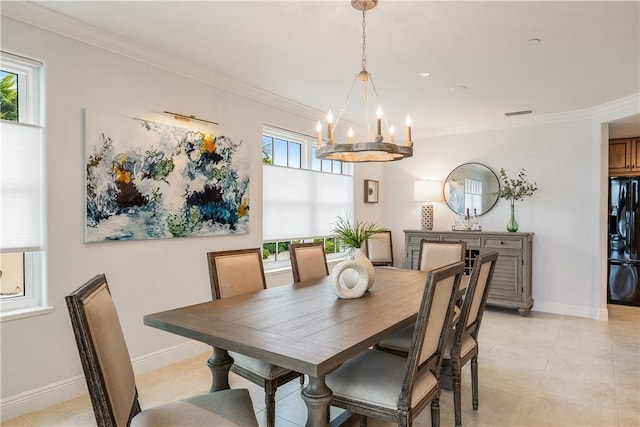 dining space with ornamental molding and a notable chandelier