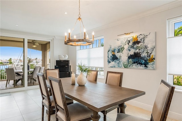 dining area with a healthy amount of sunlight, light tile patterned floors, crown molding, and a chandelier