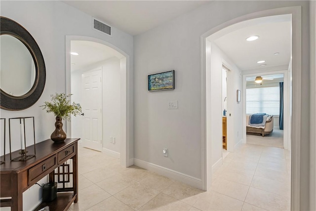 hall featuring light tile patterned floors