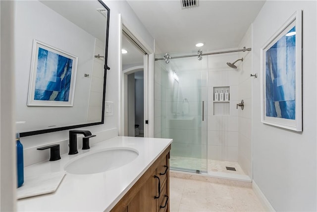 bathroom featuring walk in shower and vanity