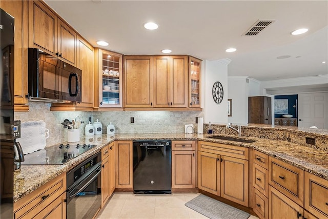 kitchen with black appliances, sink, light tile patterned flooring, light stone countertops, and ornamental molding