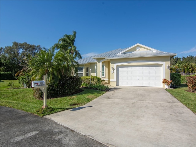 single story home featuring a garage and a front lawn