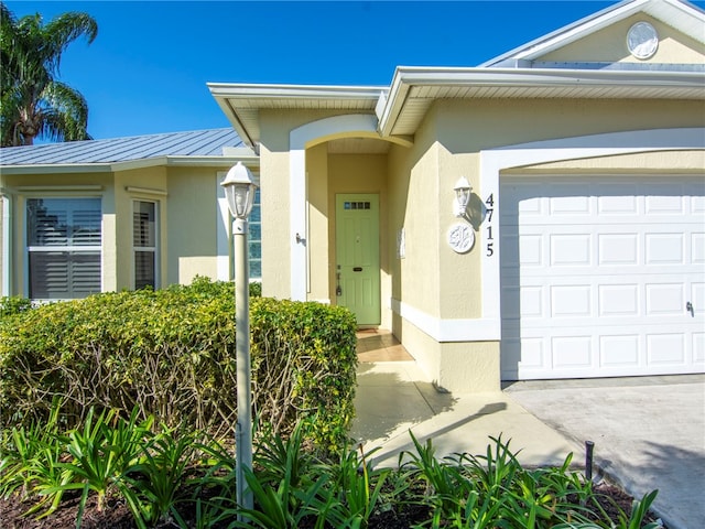 doorway to property with a garage