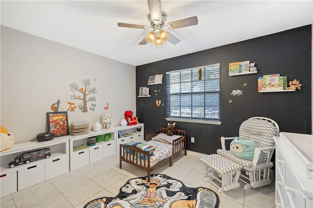 1635 71st Ct, Vero Beach, FL 32966 - bedroom featuring light tile patterned flooring, an accent wall, a ceiling fan, and a nursery area