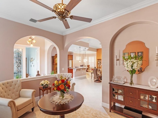 4335 65th Dr, Vero Beach, FL 32967 - living area with crown molding, ceiling fan, arched walkways, and baseboards