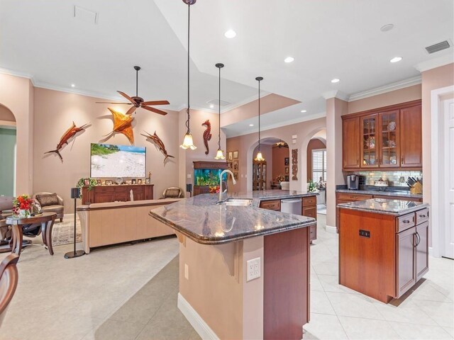4335 65th Dr, Vero Beach, FL 32967 - kitchen with arched walkways, a spacious island, a sink, open floor plan, and ornamental molding