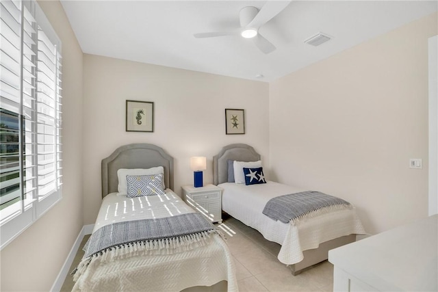 tiled bedroom featuring ceiling fan