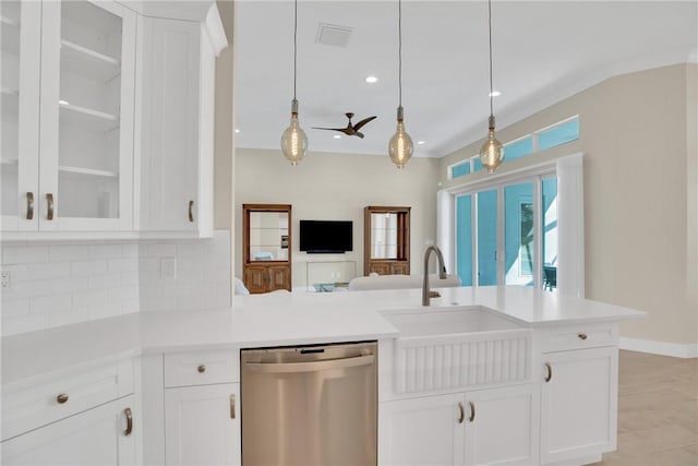 kitchen featuring sink, decorative light fixtures, white cabinets, dishwasher, and backsplash