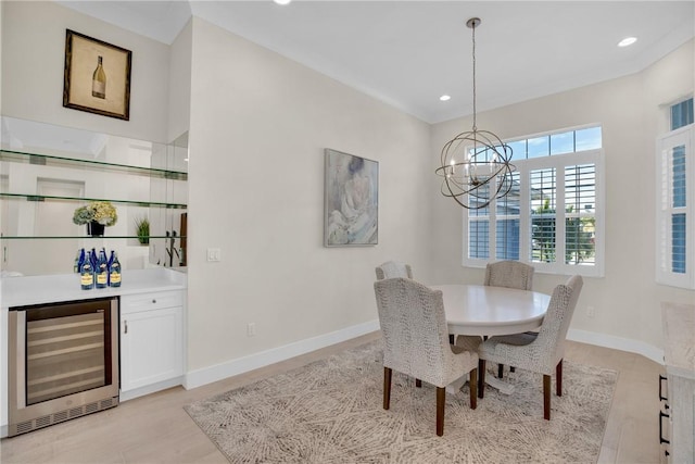 dining area featuring a notable chandelier, wine cooler, and indoor bar