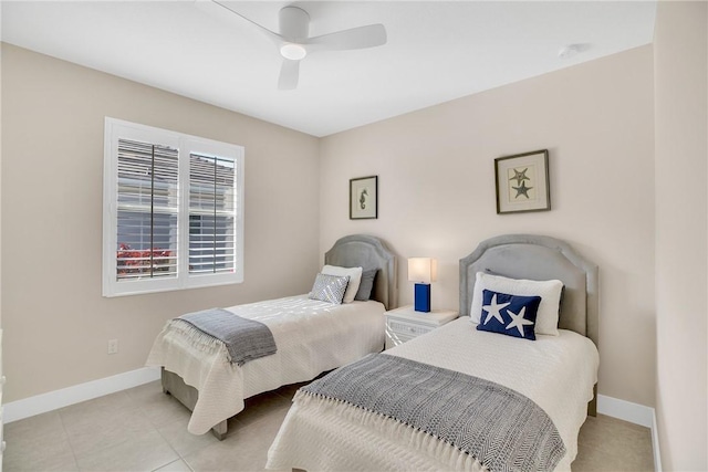 bedroom with ceiling fan and light tile patterned floors