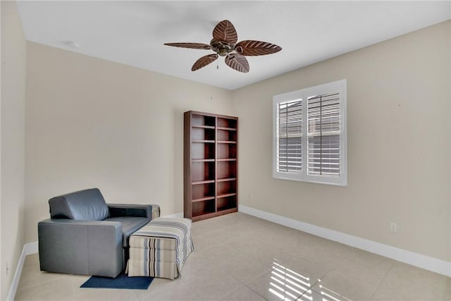 sitting room featuring light tile patterned flooring and ceiling fan