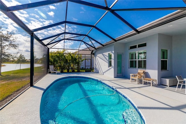 view of swimming pool featuring a patio and glass enclosure