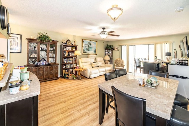 5740 Marina Dr Unit 2, Sebastian, FL 32958 - dining room featuring a textured ceiling, light hardwood / wood-style floors, and ceiling fan