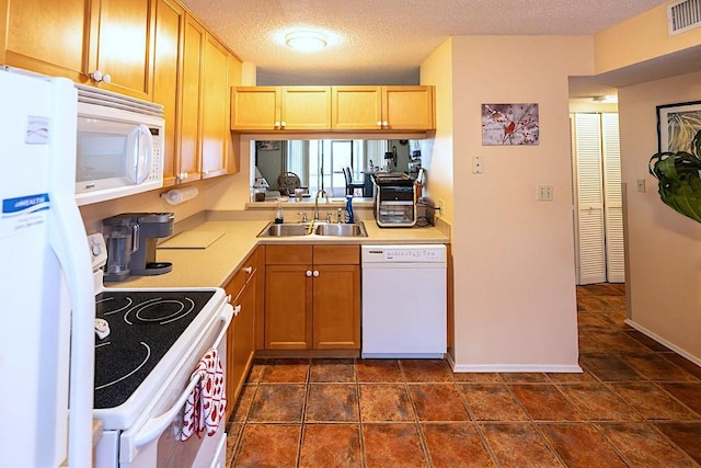 5740 Marina Dr Unit 2, Sebastian, FL 32958 - kitchen with light brown cabinetry, sink, white appliances, and a textured ceiling