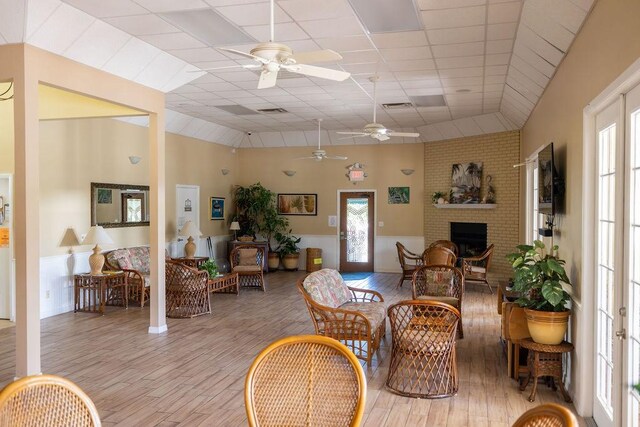 5740 Marina Dr Unit 2, Sebastian, FL 32958 - interior space featuring ceiling fan, a paneled ceiling, a fireplace, and light hardwood / wood-style floors