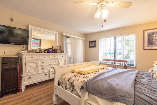 5740 Marina Dr Unit 2, Sebastian, FL 32958 - bedroom with ceiling fan, a textured ceiling, and light hardwood / wood-style floors