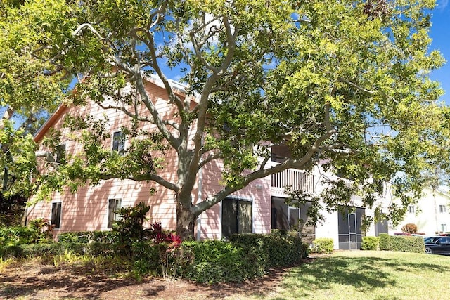 obstructed view of property featuring a front lawn