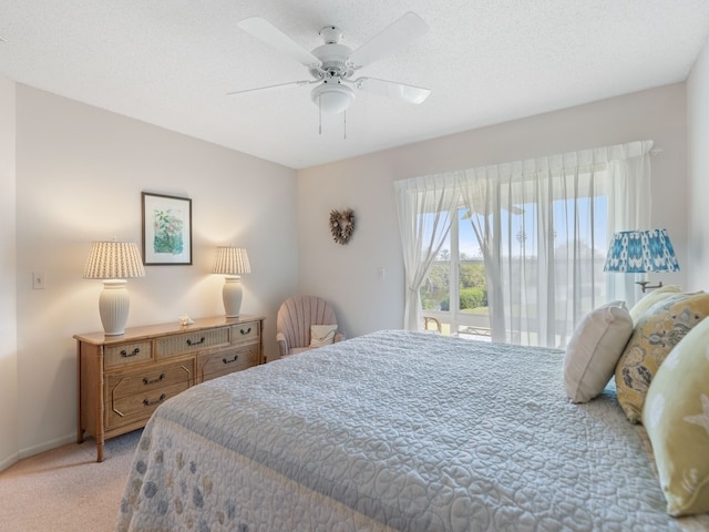 carpeted bedroom with a textured ceiling and ceiling fan