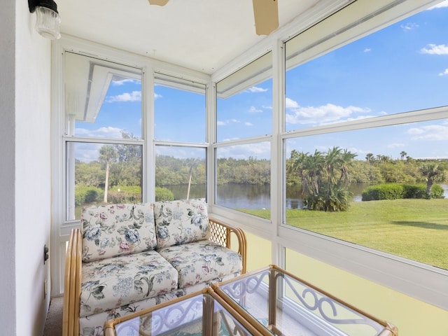 sunroom / solarium featuring a water view