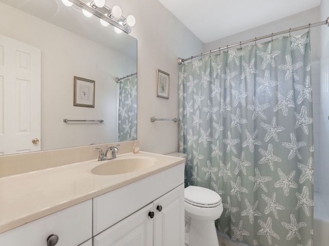 bathroom with toilet, vanity, and curtained shower