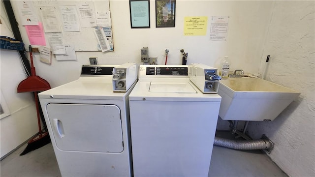 common laundry area with washer and dryer and a sink