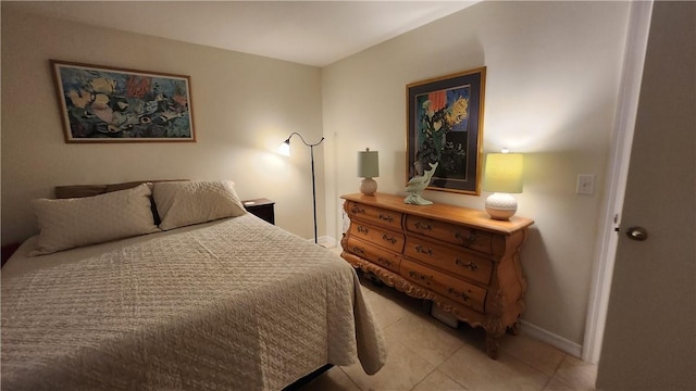 bedroom featuring light tile patterned floors and baseboards