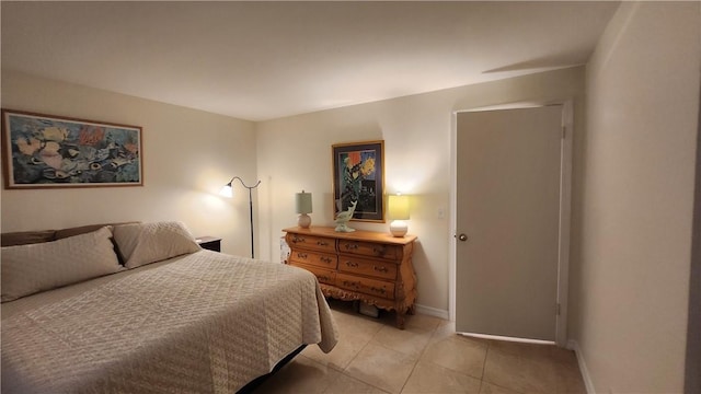 bedroom featuring light tile patterned flooring and baseboards