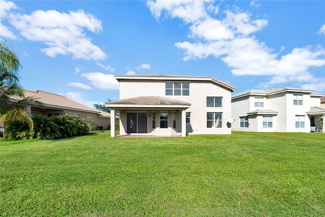 back of property featuring a yard and a patio