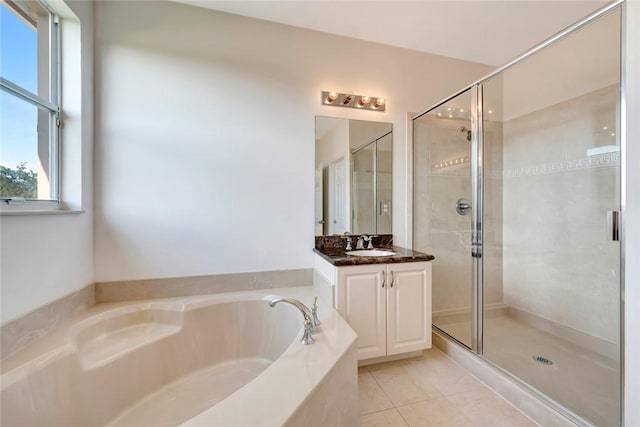 bathroom with shower with separate bathtub, vanity, and tile patterned floors