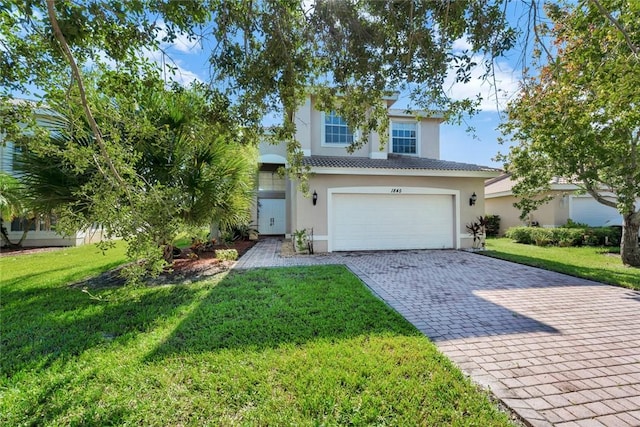 view of front of property featuring a front yard and a garage