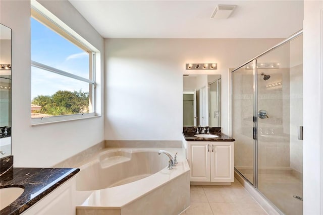 bathroom with shower with separate bathtub, vanity, tile patterned floors, and plenty of natural light