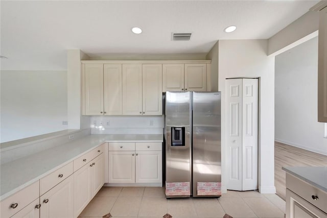 kitchen with stainless steel fridge and light tile patterned floors