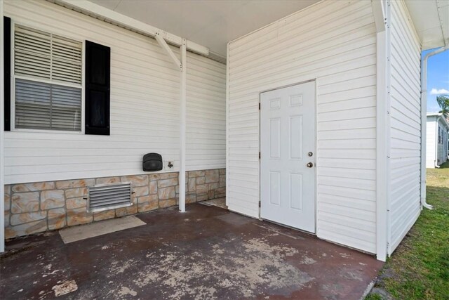 641 Hyacinth Cir, Barefoot Bay, FL 32976 - doorway to property featuring a patio area