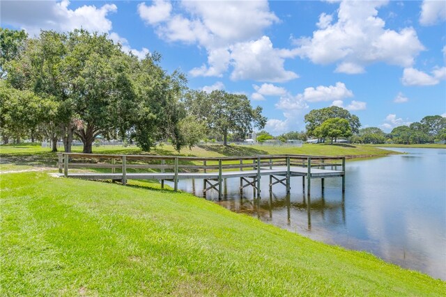 641 Hyacinth Cir, Barefoot Bay, FL 32976 - view of dock featuring a lawn and a water view
